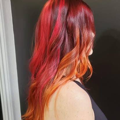 Red, magenta, and copper paneling on long wavy hair