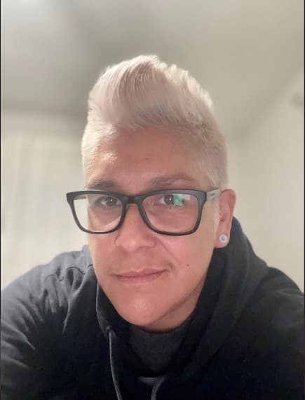 Platinum blonde pompadour, cropped tight on the sides